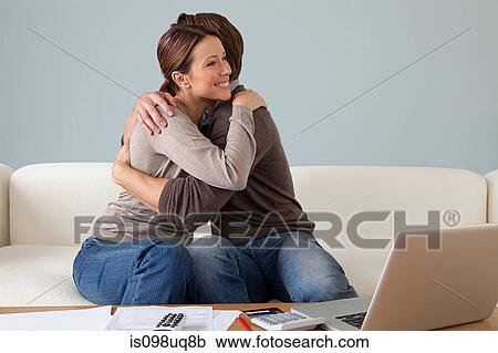 Young couple embracing, paperwork on table View Large Photo Image Stock Image - Young couple embracing, paperwork on table. Fotosearch