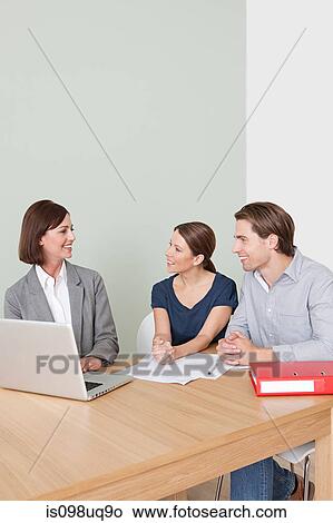Picture - Young couple with financial adviser. Fotosearch