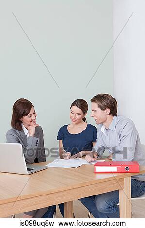 Young couple with financial adviser View Large Photo Image Stock Photo - Young couple with financial adviser. Fotosearch