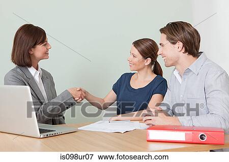 Stock Photo - Young couple with financial adviser. Fotosearch