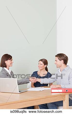 Young couple with financial adviser View Large Photo Image Stock Photograph - Young couple with financial adviser. Fotosearch