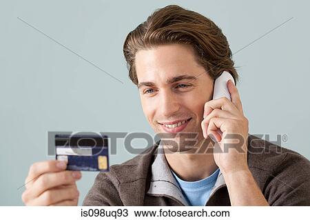 Young man on the phone with credit card View Large Photo Image Stock Image - Young man on the phone with credit card. Fotosearch