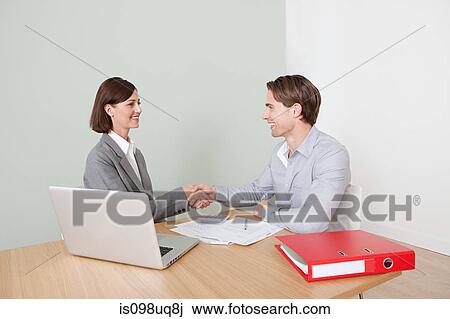 Young man shaking hands with financial adviser View Large Photo Image Stock Image - Young man shaking hands with financial adviser. Fotosearch