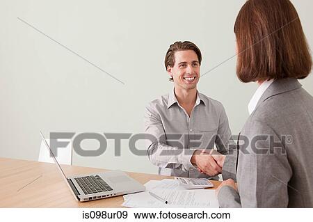 Young man shaking hands with financial adviser View Large Photo Image Stock Photo - Young man shaking hands with financial adviser. Fotosearch