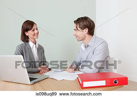 Young man with financial adviser View Large Photo Image Stock Photo - Young man with financial adviser. Fotosearch