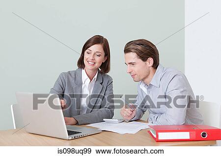 Young man with financial adviser View Large Photo Image Stock Photo - Young man with financial adviser. Fotosearch
