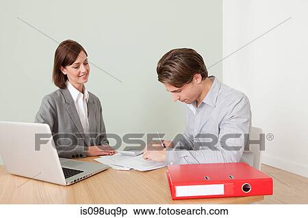Stock Photography - Young man with financial adviser. Fotosearch