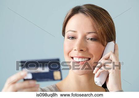 Young woman on the phone with credit card View Large Photo Image Stock Image - Young woman on the phone with credit card. Fotosearch