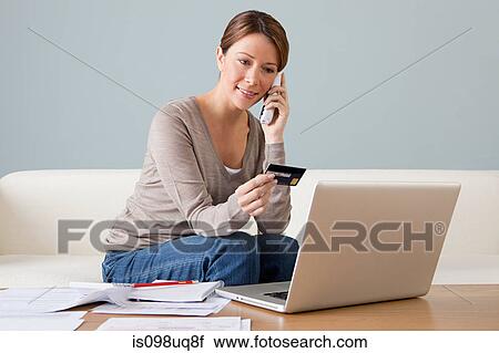 Young woman on the phone with laptop View Large Photo Image Stock Image - Young woman on the phone with laptop. Fotosearch