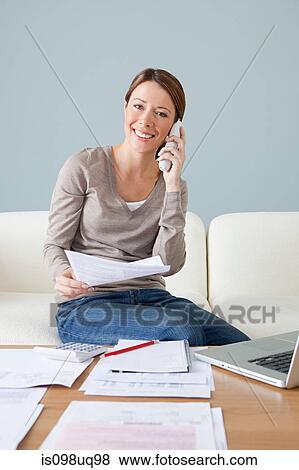 Young woman on the phone with laptop View Large Photo Image Stock Photo - Young woman on the phone with laptop. Fotosearch