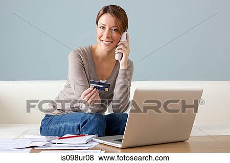 Young woman on the phone with laptop View Large Photo Image Stock Photo - Young woman on the phone with laptop. Fotosearch