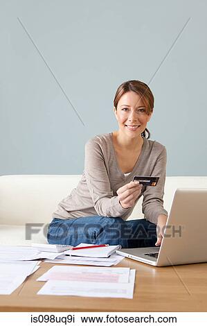 Young woman with credit card using laptop View Large Photo Image Stock Image - Young woman with credit card using laptop. Fotosearch