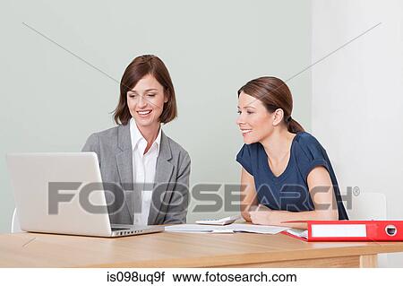 Stock Image - Young woman with financial adviser. Fotosearch