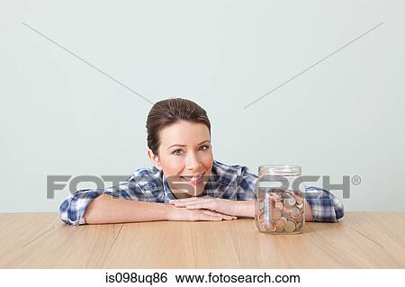 Young woman with jar of coins View Large Photo Image Stock Photograph - Young woman with jar of coins. Fotosearch