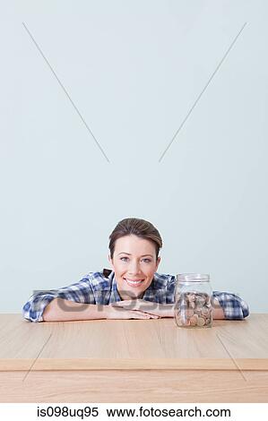 Young woman with jar of coins View Large Photo Image Stock Photography - Young woman with jar of coins. Fotosearch