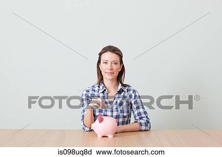 Young woman with piggy bank View Large Photo Image Stock Image - Young woman with piggy bank. Fotosearch