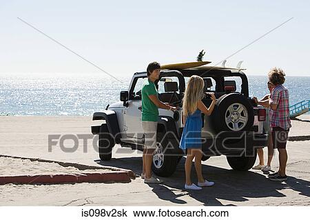 Friends by SUV at the coast View Large Photo Image Stock Image - Friends by SUV at the coast. Fotosearch