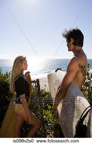 Surfer couple near the sea View Large Photo Image Stock Image - Surfer couple near the sea. Fotosearch