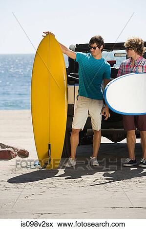 Stock Photo - Two young men with surfboards. Fotosearch