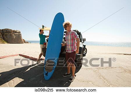 Two young men with surfboards View Large Photo Image Stock Photography - Two young men with surfboards. Fotosearch