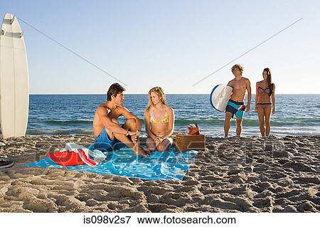 Young couples at the beach View Large Photo Image Stock Photo - Young couples at the beach. Fotosearch