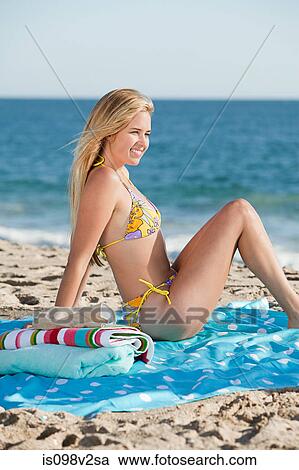 Stock Image - Young woman on the beach. Fotosearch