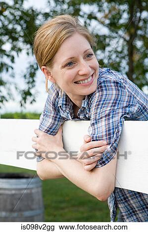 Cheerful woman in paddock View Large Photo Image Stock Image - Cheerful woman in paddock. Fotosearch