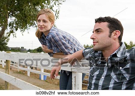 Stock Image - Couple in paddock. Fotosearch