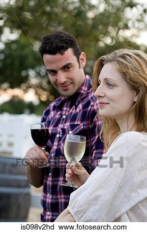Couple tasting wine in vineyard View Large Photo Image Stock Image - Couple tasting wine in vineyard. Fotosearch