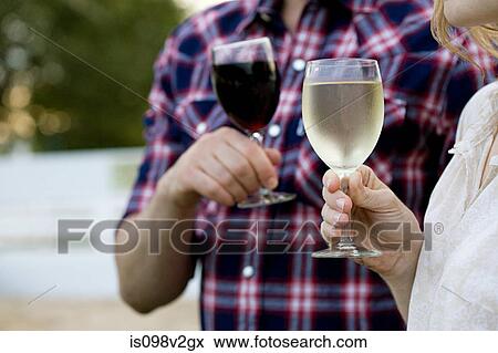 Stock Photo - Couple tasting wine in vineyard. Fotosearch