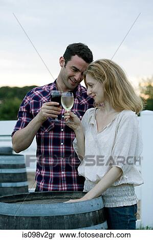 Stock Photography - Couple tasting wine in vineyard. Fotosearch