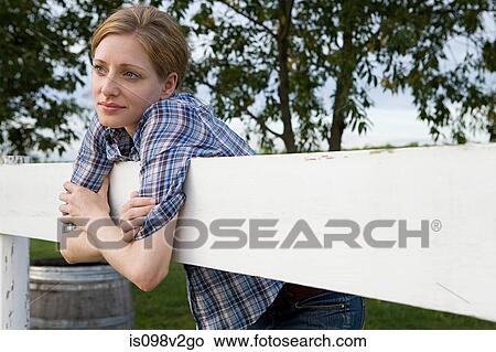 Mid adult woman in paddock View Large Photo Image Picture - Mid adult woman in paddock. Fotosearch