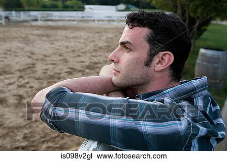 Stock Image - Young man in paddock. Fotosearch