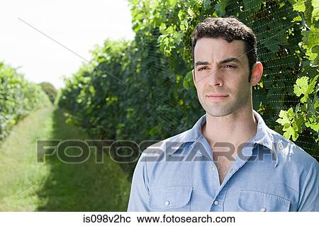 Stock Image - Young man in vineyard. Fotosearch