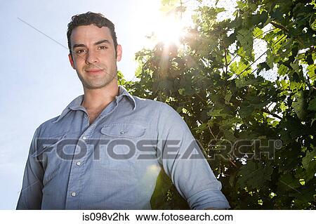 Young man in vineyard View Large Photo Image Stock Image - Young man in vineyard. Fotosearch