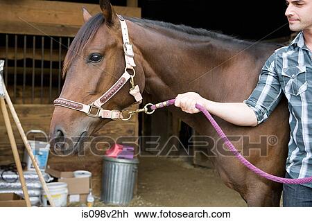 Stock Image - Young man with horse. Fotosearch