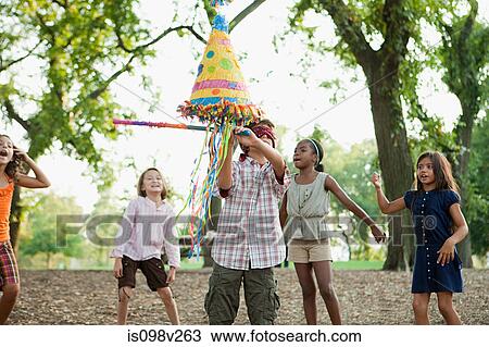 Boy at birthday party hitting pinata View Large Photo Image Stock Image - Boy at birthday party hitting pinata. Fotosearch