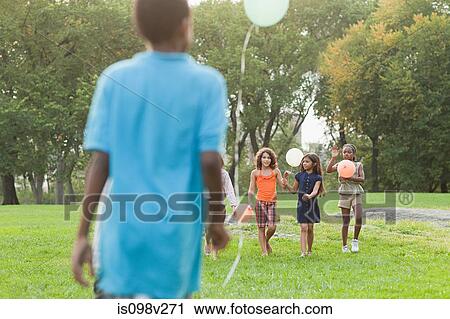 Children at birthday party holding balloons View Large Photo Image Stock Image - Children at birthday party holding balloons. Fotosearch