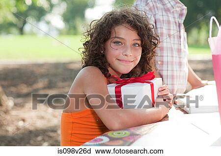 Girl at birthday party with birthday present View Large Photo Image Stock Image - Girl at birthday party with birthday present. Fotosearch