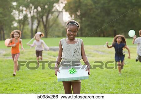 Girl with birthday present View Large Photo Image Stock Photograph - Girl with birthday present. Fotosearch