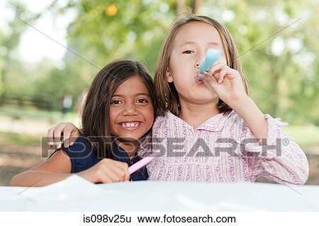 Girls at birthday party with party blowers View Large Photo Image Stock Photograph - Girls at birthday party with party blowers. Fotosearch