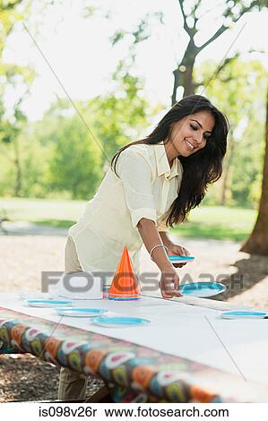 Stock Photography - Mother preparing for birthday party. Fotosearch