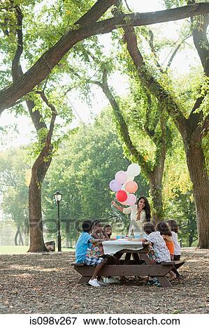 Stock Photo - Outdoor birthday party with balloons. Fotosearch