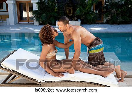Affectionate couple on sun lounger View Large Photo Image Stock Photograph - Affectionate couple on sun lounger. Fotosearch