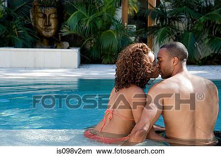 Picture - Couple kissing in swimming pool. Fotosearch