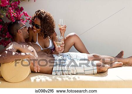 Couple relaxing outdoors with wine View Large Photo Image Stock Photograph - Couple relaxing outdoors with wine. Fotosearch