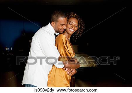 Stock Photo - Glamorous young couple hugging. Fotosearch
