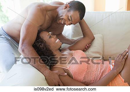 Happy young couple on sofa View Large Photo Image Stock Image - Happy young couple on sofa. Fotosearch