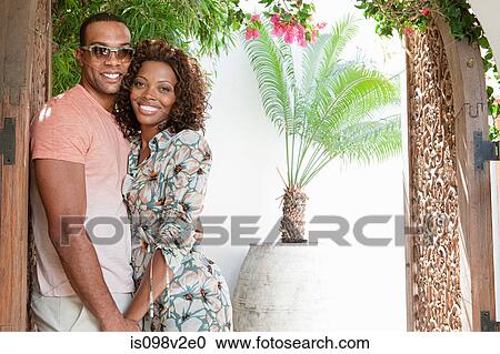 Stock Image - Young couple in doorway. Fotosearch