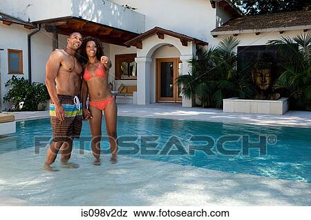 Young couple standing in swimming pool View Large Photo Image Stock Photo - Young couple standing in swimming pool. Fotosearch